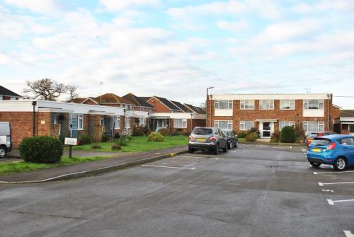 Exterior shot of the front entrance and car park to Lawns Court